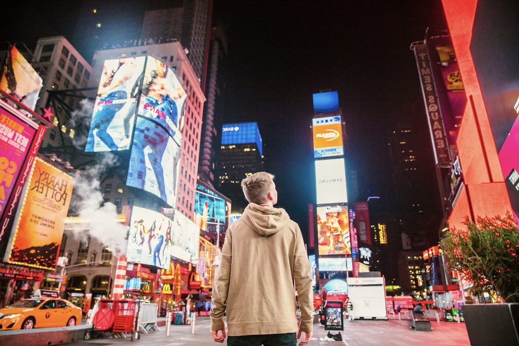 boy standing watching in times square